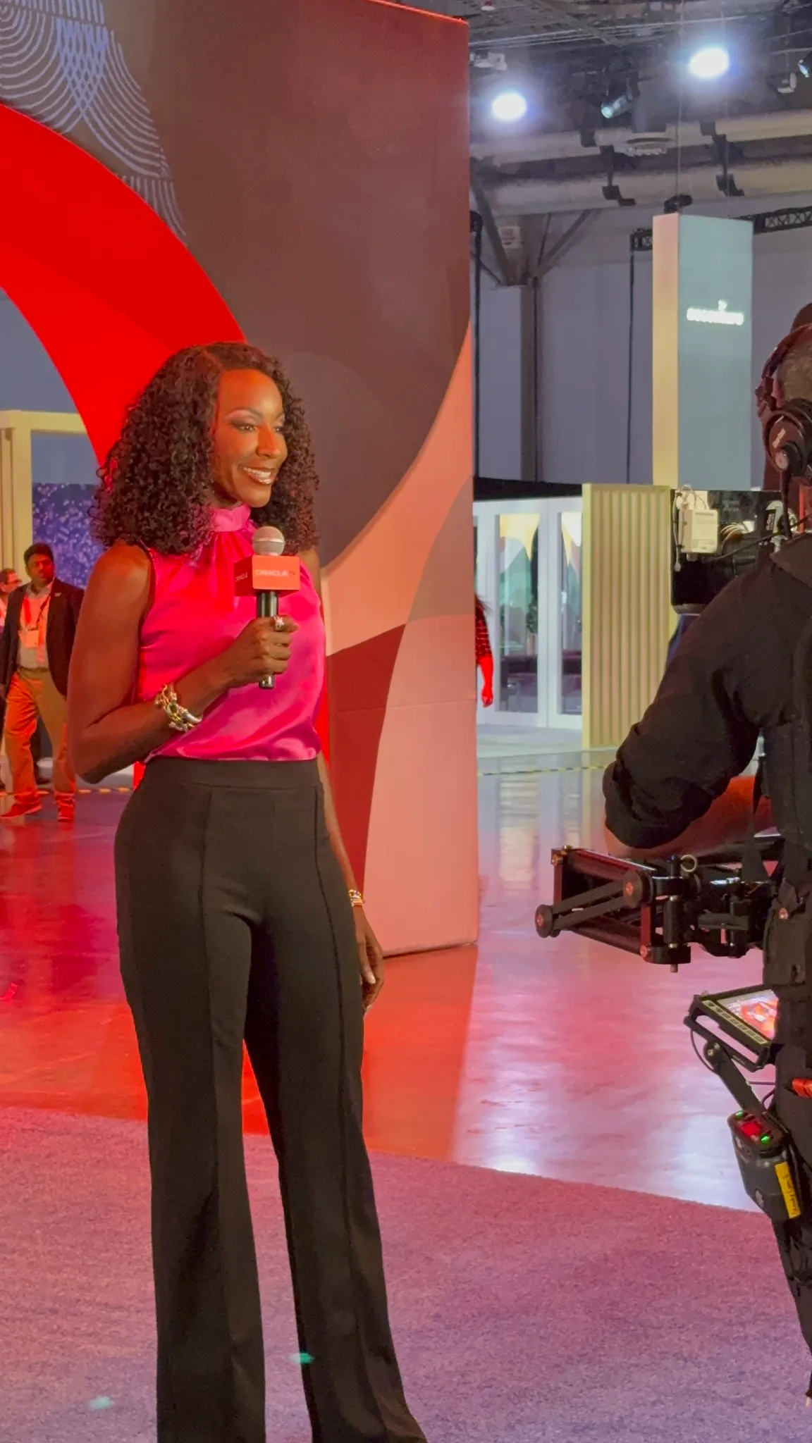 Kay Malcolm on camera with a microphone